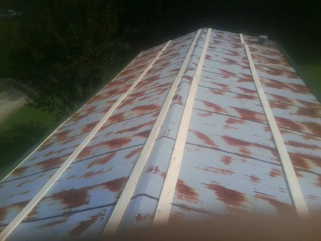 Rusted metal roof panels with new wood purlins before replacement — Storm Damage Roof Repair in Laurel Bloomery by Roofing Brothers