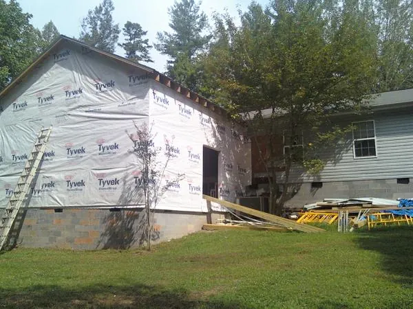 Tyvek wrapped gable on a new room addition beside an existing home in Laurel Bloomery